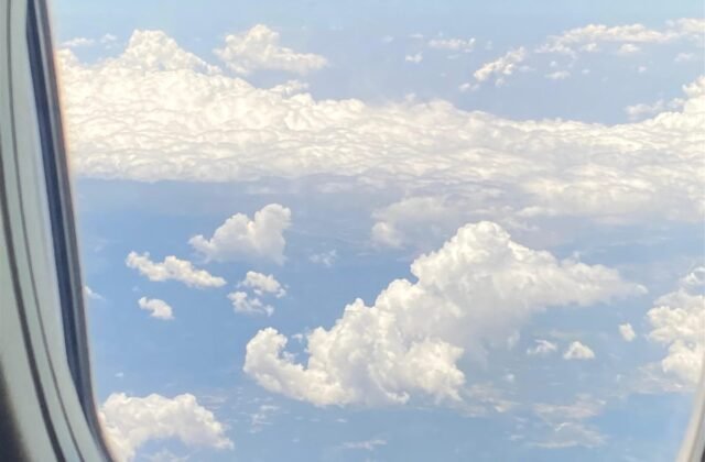 نمای آسمان و ابرها از پنجره هواپیما